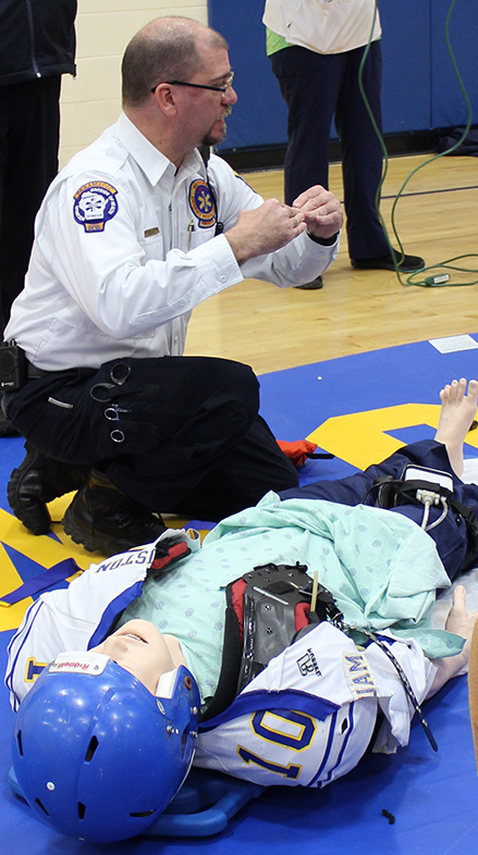 Person practicing CPR on a dummy